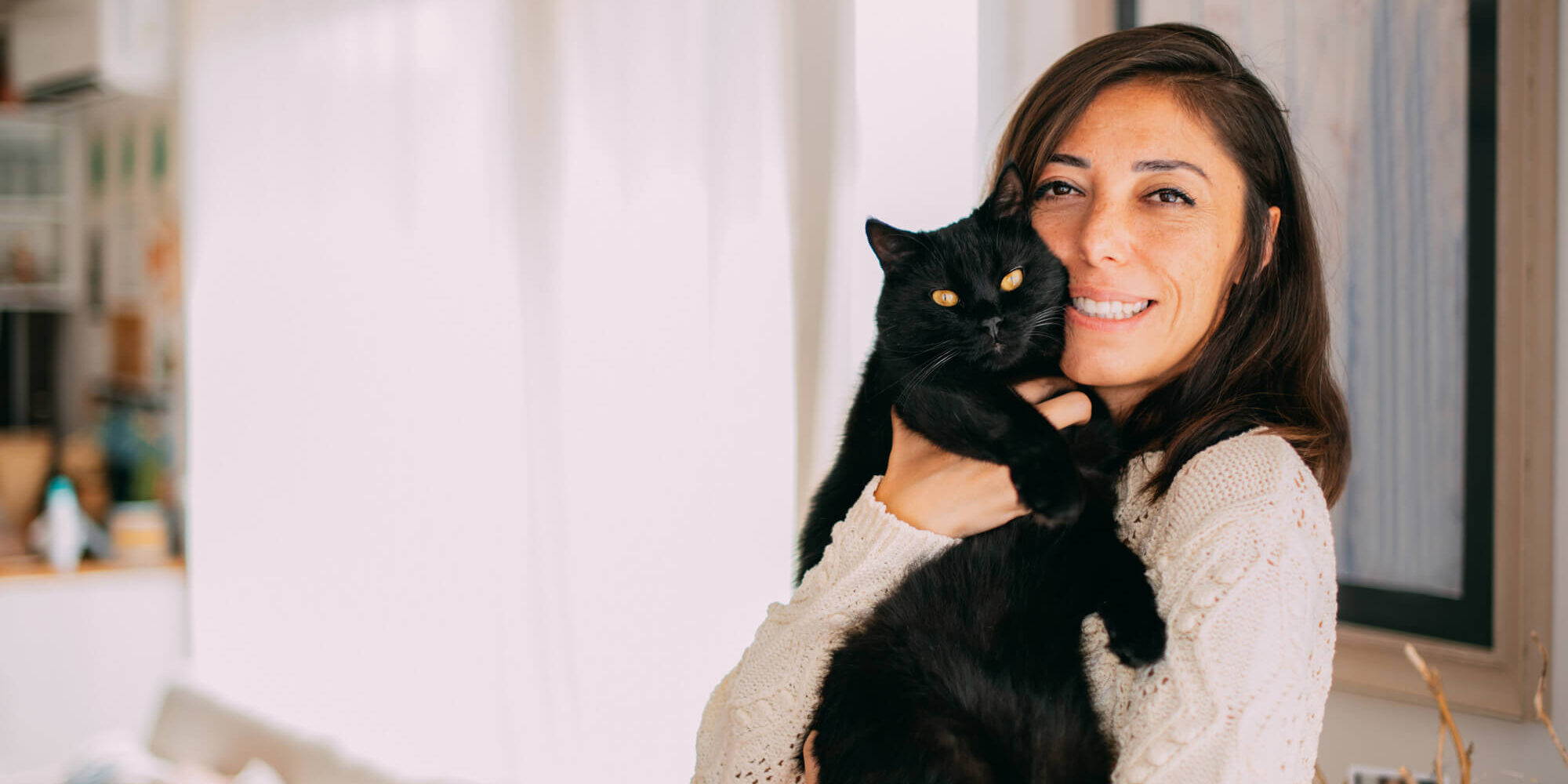 Woman Holding Black Cat